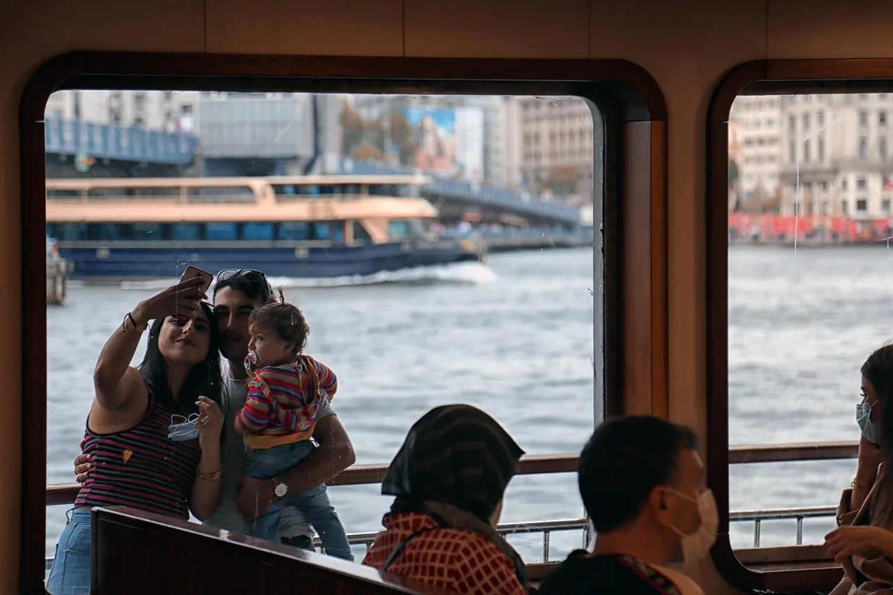 ship, family, nature, cruise, river cruise, cruising, selfie, picture taking, phone photography, family photo, carrying child, mother, father, child, vacation, travel, harbor, people, passengers, cruise passengers, water, boat, tourism. Boat tour costs add up fast once transport joins the ticket price