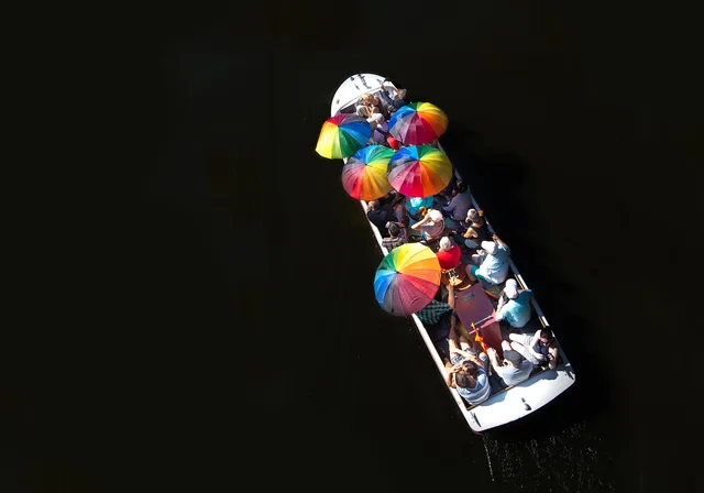 boat, cruise, ship, canal, umbrella, sunny, tourism, boat tour, tour, guide, guided tour, river, europe, nature, vacation, passenger, marine, summer, hot, colorful, black river, black boat, black umbrella. Where the most reliable boat tour guides can actually be found